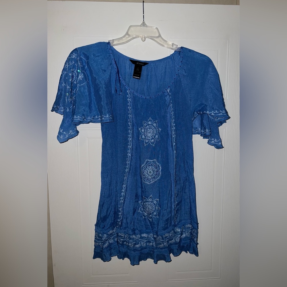 Women’s short sleeve blue top, size small but runs big.
